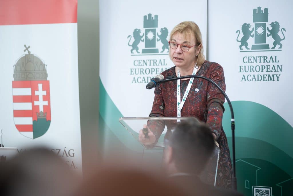 Női előadó beszédet tart a CEA logója előtt
