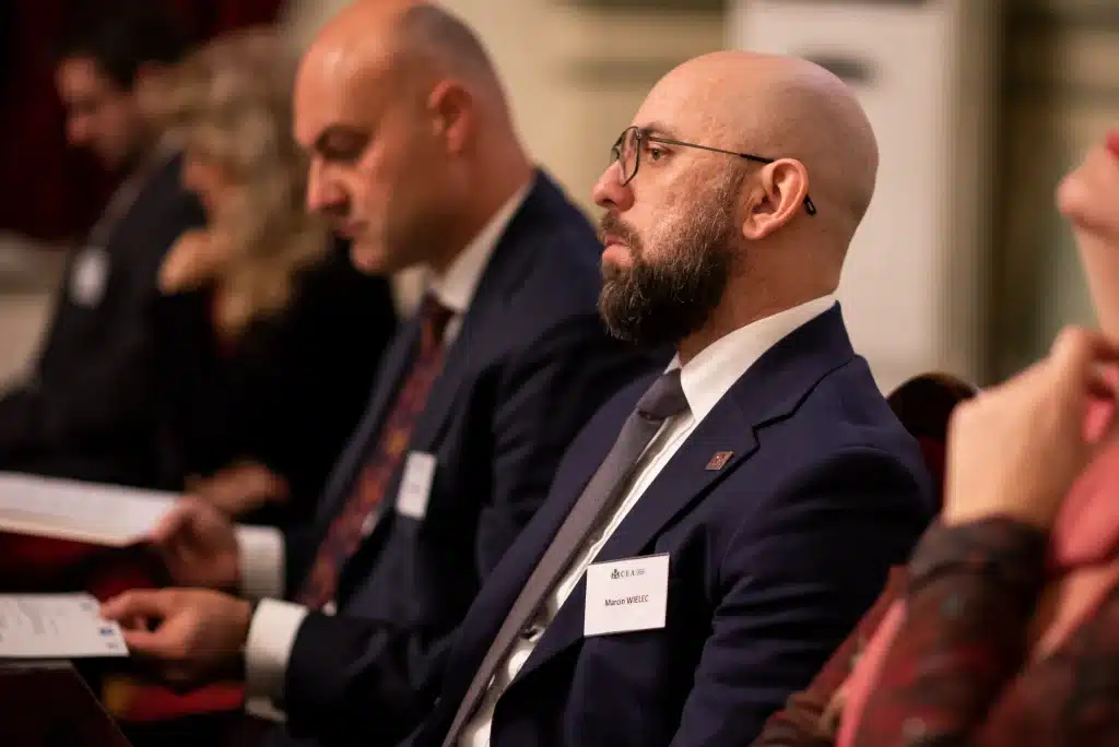 Speakers at a panel discussion in front of the CEA logo