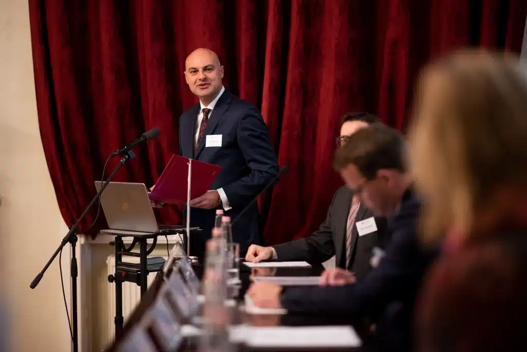 Man giving a lecture with notes