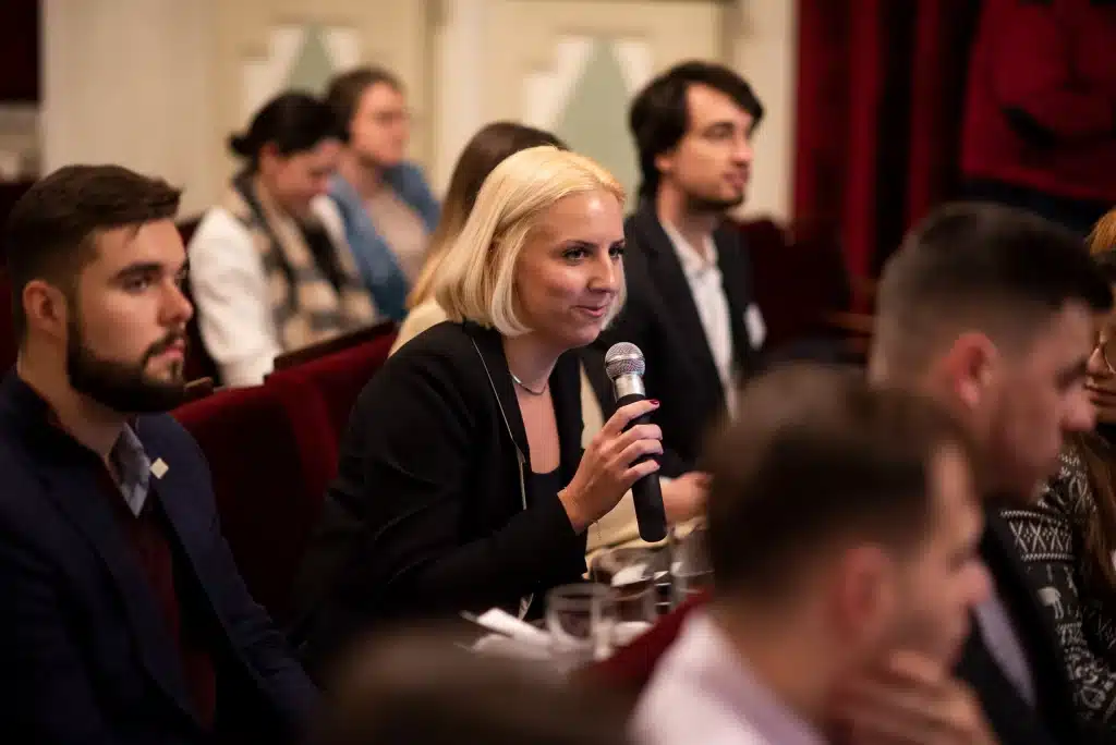 Female participant asking a question at the event