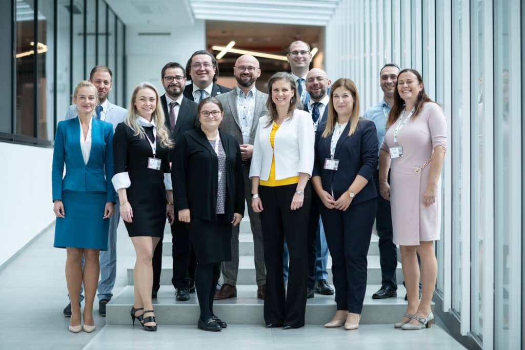 Group photo of participants in suits at the conference