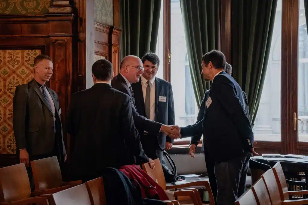 Two men shaking hands during a conference break