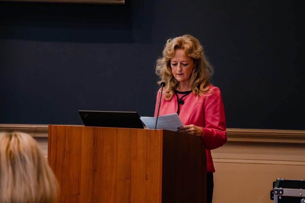 Young woman giving a presentation holding a microphone