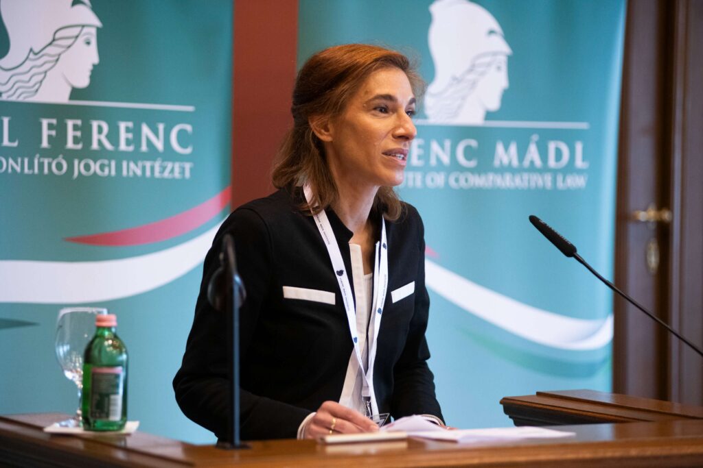 Male speaker giving a speech in front of the Central European Academy logo