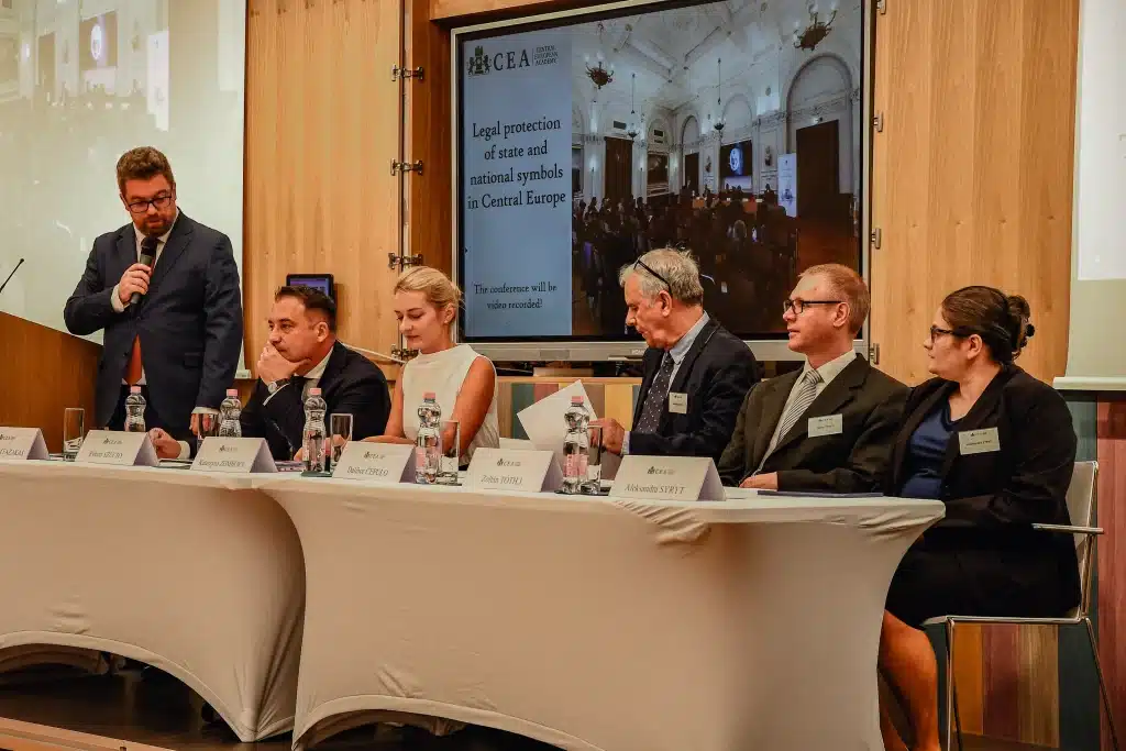 Speakers at a panel discussion in front of the CEA logo