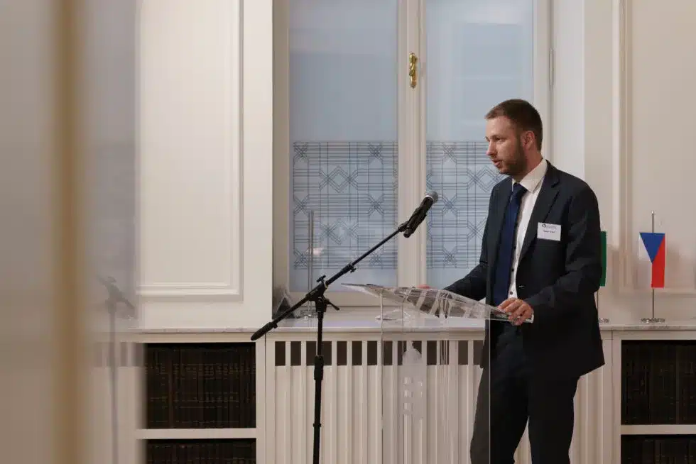 Man giving a lecture with notes