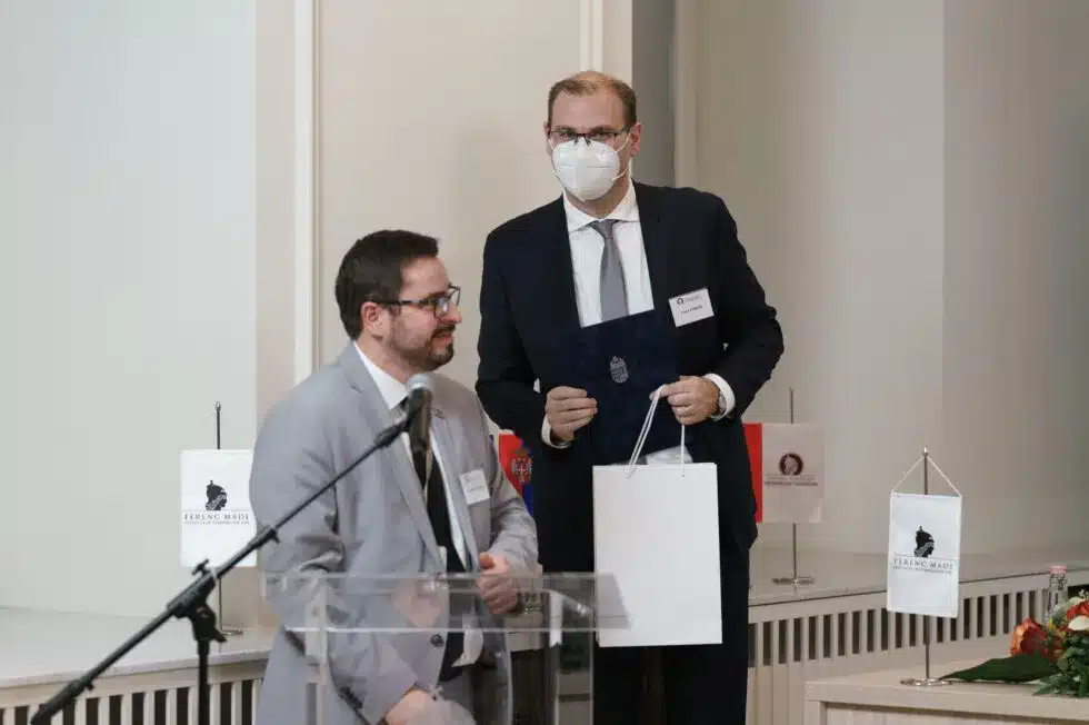 Award ceremony with a handshake in front of an audience