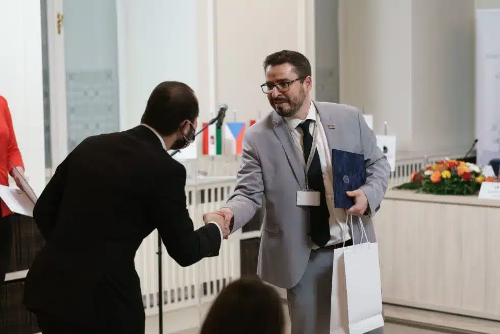 Award ceremony with a handshake in front of an audience