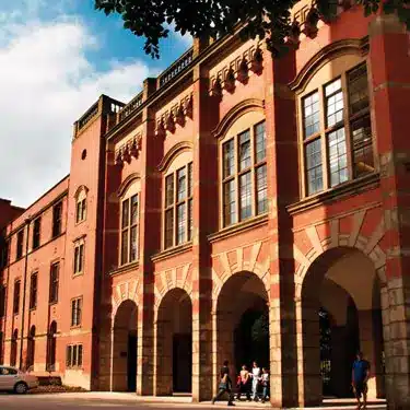 Historic university building made of brick with an arched façade