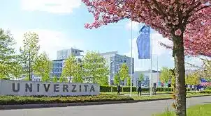 Modern university campus building in a spring setting