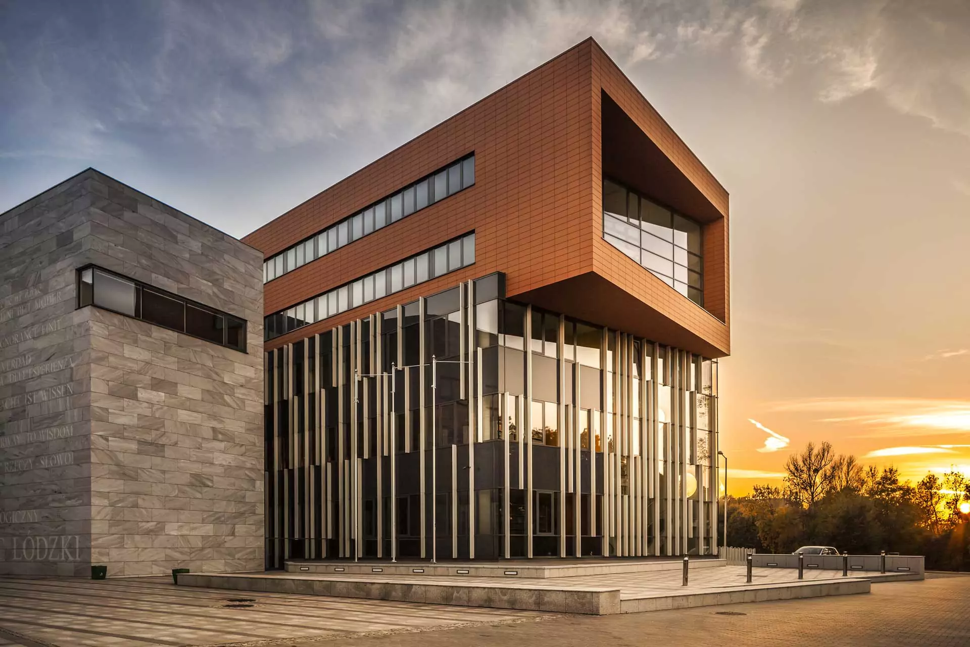 Modern university building with a red brick façade.