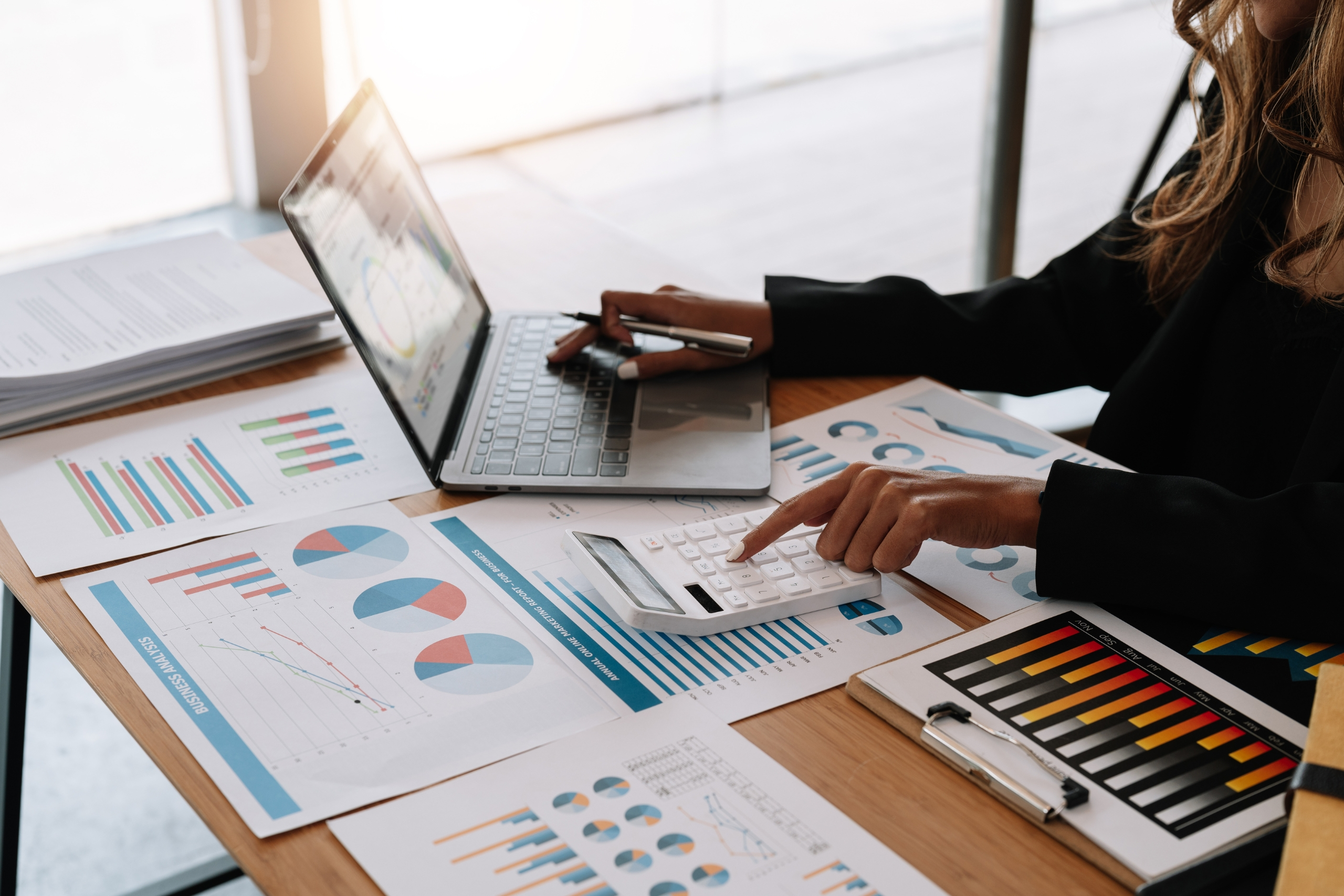 Business analysis with charts and a laptop