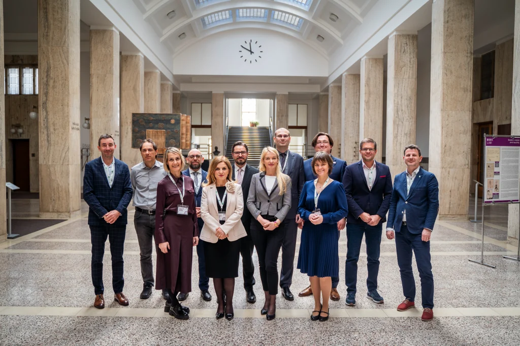 Group photo of CEA event participants in a ceremonial hall