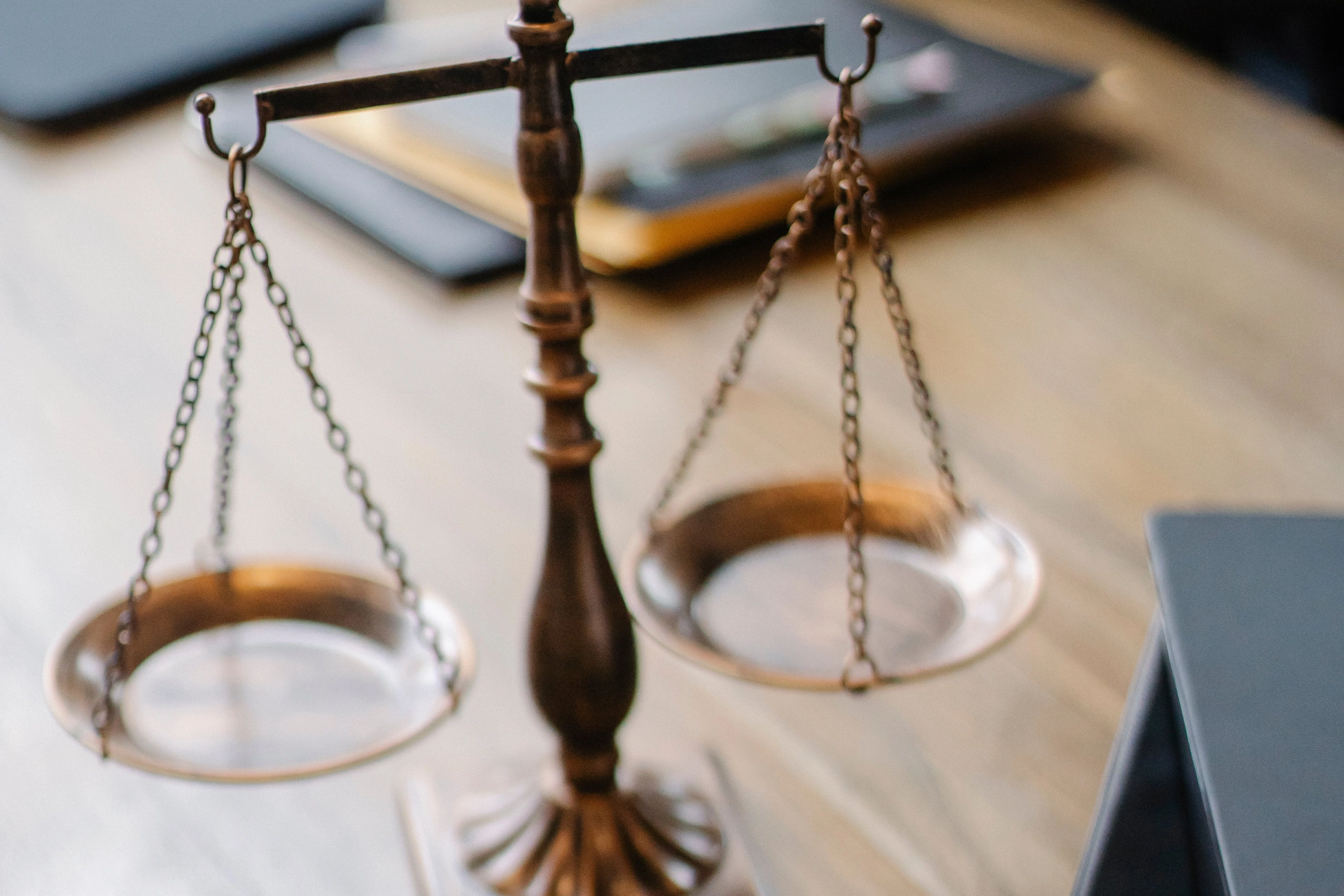 Balance scale symbol on wooden desk