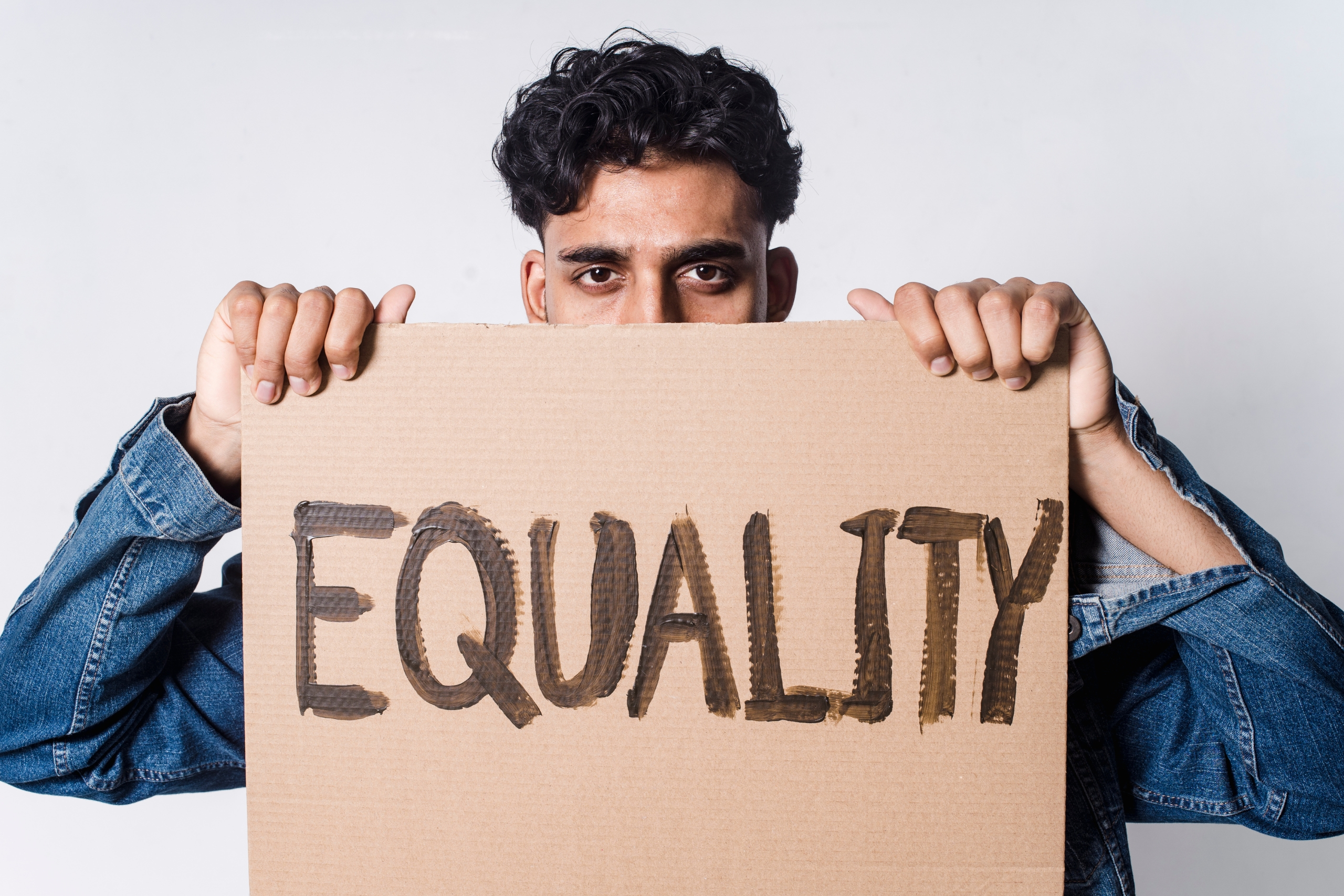Man holding a sign demanding equality