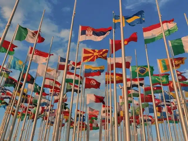 Multiple national flags on flagpoles